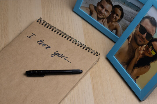 Love letter in front of photos in frames with happy smiling travelling couple of young people.