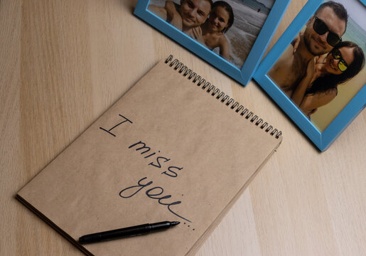 Photo frames with happy young travelling couple and letter in notebook with text I miss you. 