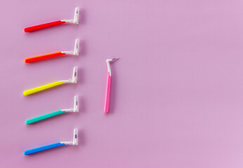 Multi-Coloured brushes for cleaning braces and interdental space on a pink background. Oral hygiene is the to successful treatment. Top view. Flat lay. Copy space for text.