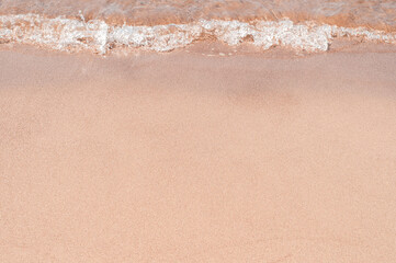 Transparent sea waves on the warm sandy seashore. Sea vacation and travel.