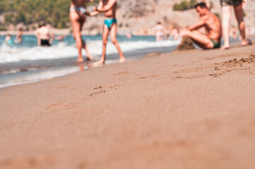 Transparent sea waves on the warm sandy seashore. Sea vacation and travel.