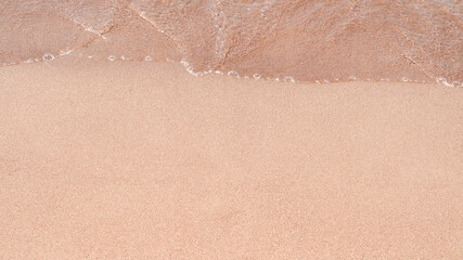 Transparent sea waves on the warm sandy seashore. Sea vacation and travel.