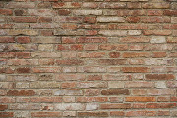 Seamless brick wall with red, grey and brown stones, stone wall background with space for text and no person
