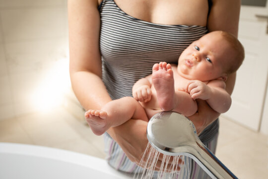 Diaper Free Baby Is Washed Under Running Water