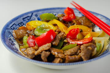 Cooked marinated beef slices with a savory black beef sauce, peppers and onions