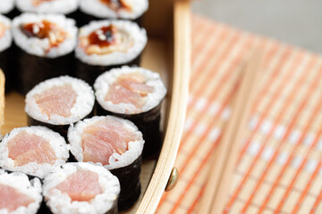 Set of maki sushi on wooden boat tray