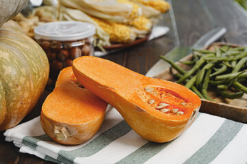 Pumpkin cut into halves on dark wooden table