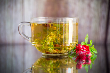 natural hot tea from various summer herbs in a glass cup
