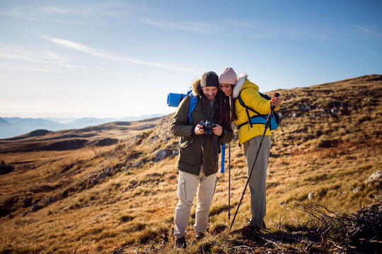 Hikers couple watching photo on their camera