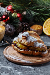 Fototapeta na wymiar New Year's breakfast with croissants. New Year's croissant with chocolate and baked orange