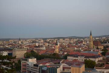 Cluj-Napoca,Romania- 07.20.2019: Aerial photography over the town center at the sunset. Sfantul Mihail Church,located in the center of the city,in Matei Corvin Square (Mathias Rex).