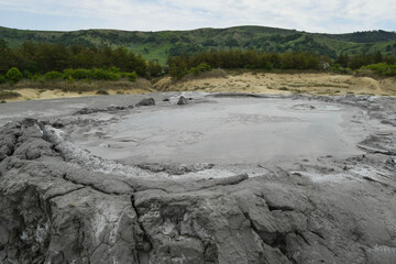 Bubbling crater of a mud volcano. Close up view onto gas bubble exploding in crater of mud volcano. Mud volcano at Paclele Mari, near Buzau, Romania.