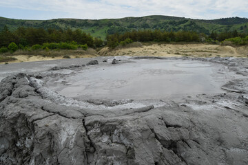 Bubbling crater of a mud volcano. Close up view onto gas bubble exploding in crater of mud volcano. Mud volcano at Paclele Mari, near Buzau, Romania.