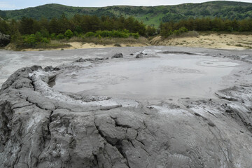 Bubbling crater of a mud volcano. Close up view onto gas bubble exploding in crater of mud volcano. Mud volcano at Paclele Mari, near Buzau, Romania.