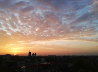 Beautiful sunset or sunrise sky above clouds with dramatic light.