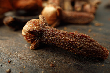 Heap of clove spice on wooden table