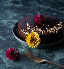 Dark chocolate cake with yellow and red flowers