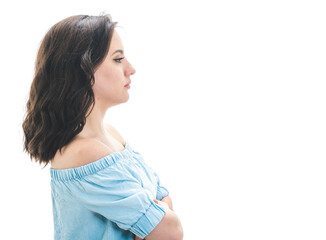 Side view of young woman with crossed arms standing, Profile of beautiful girl looking to copy space, isolated on white background