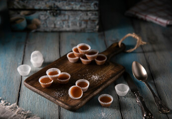 Homemade caramel candies on a rustic wooden table