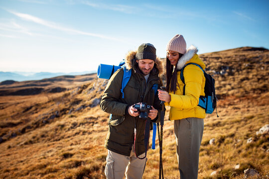 Hikers couple watching photo on their camera