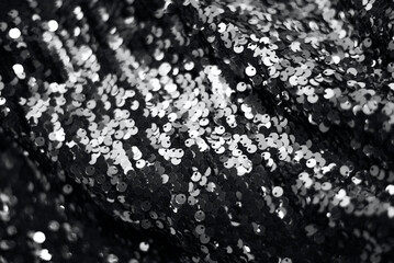 Festive background of trendy gray sequins. Silver universal shining background.