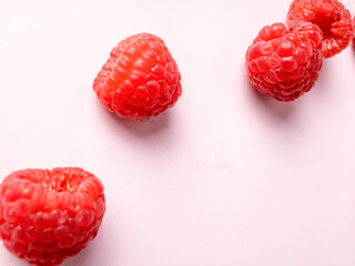 Red raspberries on pink backdrop