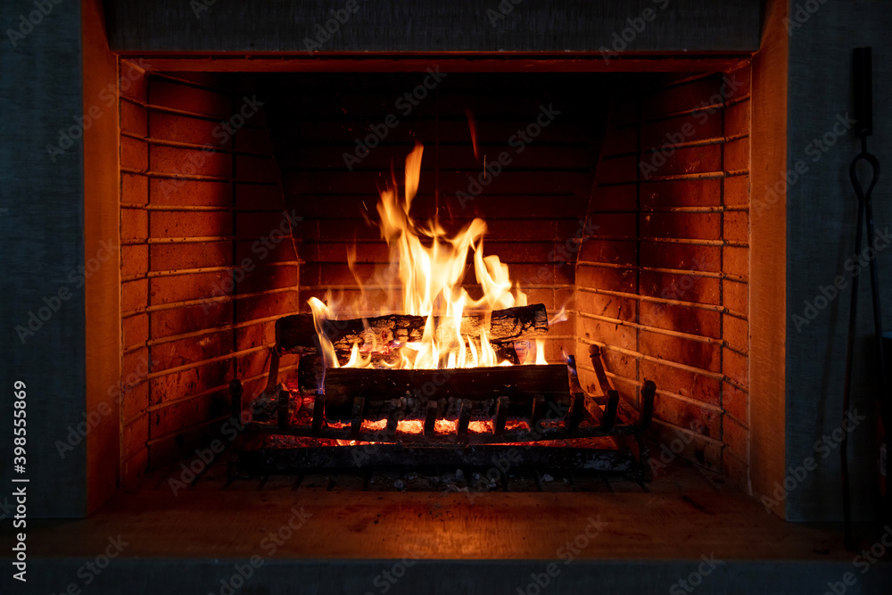 Wall mural Fireplace, fire burning, cozy warm fireside, christmas home.