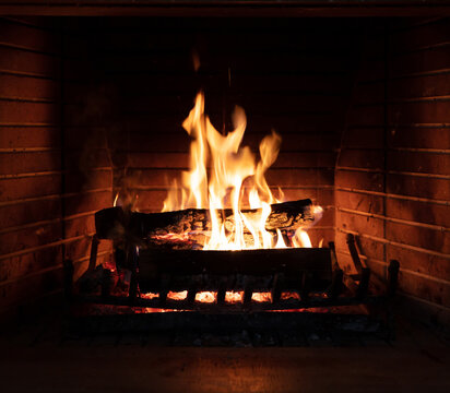 Fireplace, fire burning, cozy warm fireside, christmas home.