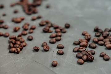 Grains of coffee on a gray concrete surface