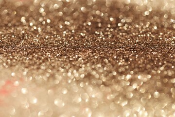 Beige  glitter glow background. Rose gold shiny texture.New Year and Christmas background.Wallpaper phone shining glitter.glitter macro background with shining bokeh.Shining texture
