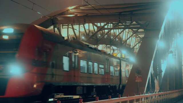 A train rides on the Andreevsky bridge over the Moscow river, Russia. Komsomolsky Ave. Vernadsky, the center, Moscow ring road and the shopping center "Capitol". 27.11.2020