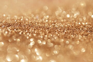 Beige gold glitter glow background. Rose gold shiny texture.New Year and Christmas background.Wallpaper phone shining glitter.glitter macro background with shining bokeh.Shining texture