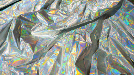 Sparkling colored fabric holographic background. Holographic iridescent surface wrinkled foil pastel