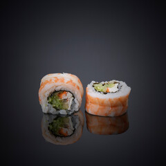 Japanese rolls on a gray-black background.
