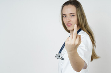 Young female doctor showing middle finger, impolite and rude gesture expression.