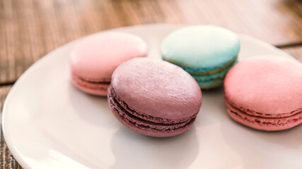 Sweet and colourful french macarons on table.