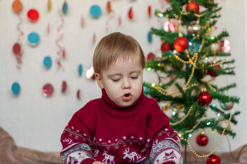 Fototapeta na wymiar Portrait of a cute boy. Children's emotions. Christmas and new year.