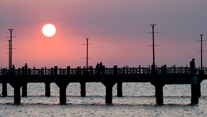 Bangsan Chonburi Thailand jetty and sunset. At Bangsan beach. Ao Thai Ocean. Beautiful sunset landscape, wooden shore jetty and colorful sky and cloud. Artistic beach sunset under wonderful sky. Recre