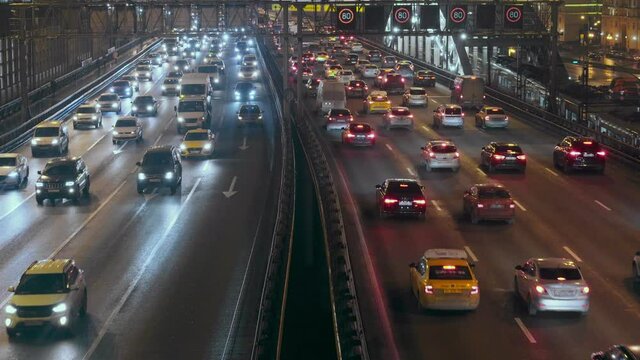 Car traffic on the Andreevsky bridge over the Moscow river at night in Moscow, Russia 27.11.2020