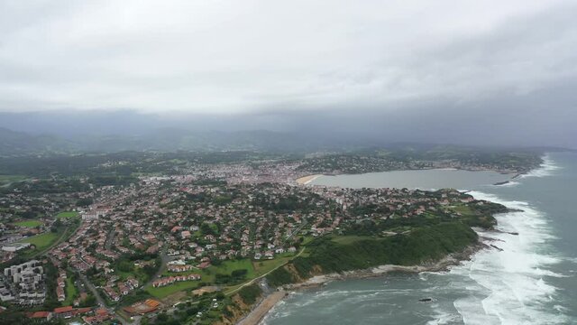 Aerial shot of ocean coast in the south west of France during a cloudy day with wind.