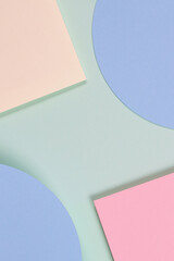 Abstract geometric texture background of soft green, pastel pink, light blue, yellow color paper. Top view, flat lay