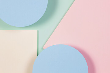 Abstract geometric texture background of soft green, pastel pink, light blue, yellow color paper. Top view, flat lay