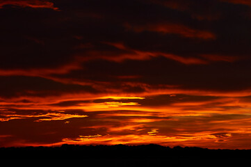 Red clouds at sundown like a burning sky of a spectacular sunset from La Savina (Formentera, Pityusic Islands, Balearic Islands, Spain)