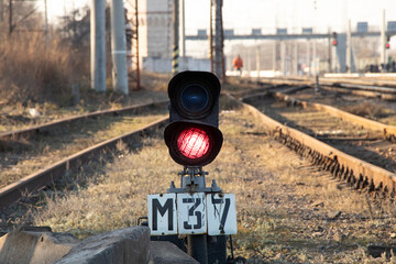 railway traffic light with red light on on the railroad in the afternoon in Ukraine