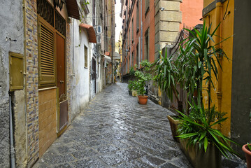 Fototapeta na wymiar Naples, Italy, December 10, 2020. An old street in the historic city center on a winter day.