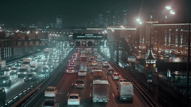 Car traffic on the Andreevsky bridge over the Moscow river at night in Moscow, Russia 27.11.2020