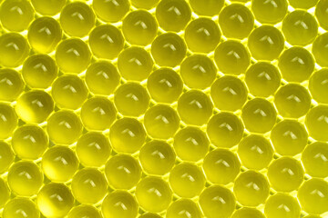 Yellow gel balls. Abstract bright geometric hydrogel background. Macro
