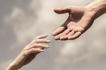 Giving a helping hand. Hands of man and woman on blue sky background. Lending a helping hand....
