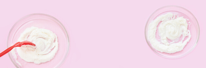 Collagen white powder. Pastel color background. Health product. Woman cosmetics concept. Sport supplement. Skincare cosmetics. Horizontal banner. Pink monochrome. Spoon