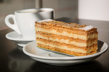 pastry with puff pastry and custard with a Cup of cappuccino on the background. 